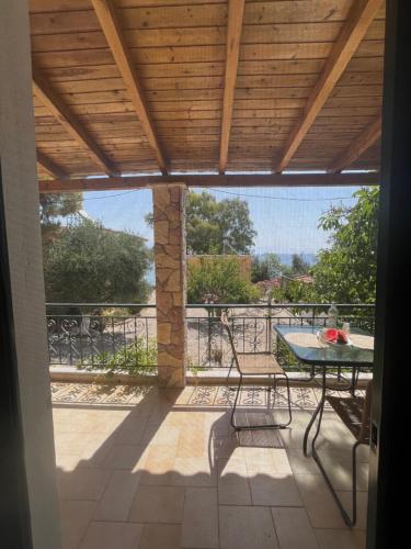 a patio with a table and chairs on a balcony at 9 Muses Villas in Chrani