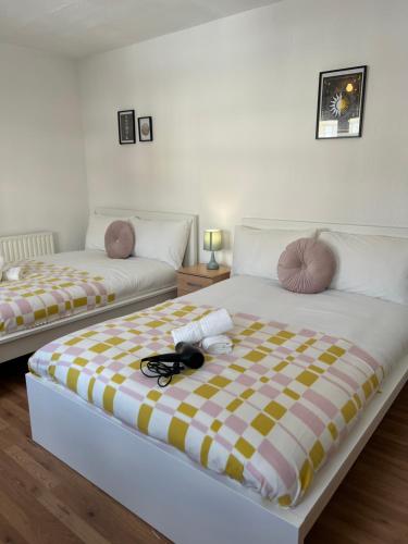 two beds sitting next to each other in a room at Lovely Rooms in Camden Town-Central London in London