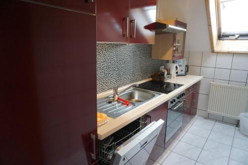 a small kitchen with a sink and a stove at Waldhotel Weitblick in Fichtach