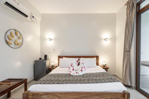 a bedroom with a bed with a backpack on it at YU Resort in Msambweni