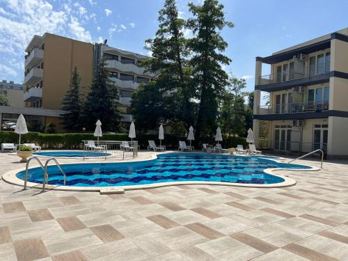 a swimming pool in front of a building at Sole Mar in Sunny Beach