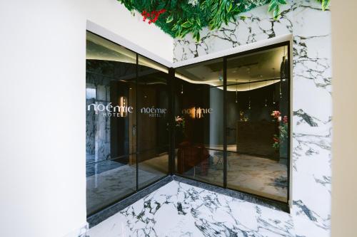 a facade of a building with glass windows at Noemie Hotel in Himare