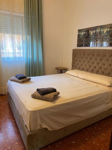 a bedroom with a large bed with two towels on it at Genial casa en centro in Ceuta