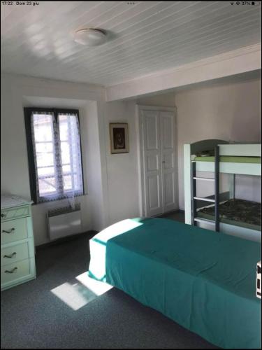 a bedroom with a bed and two bunk beds at Casa Galett in Novaggio