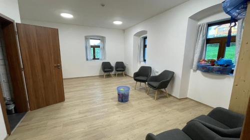 a room with chairs and a table and a door at Turistická chata Libínské Sedlo in Prachatice