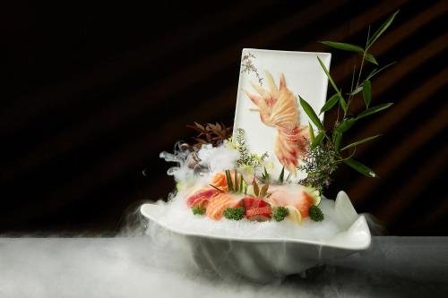 a plate of food with birds and flowers on it at Crowne Plaza Chongqing New North Zone by IHG in Chongqing
