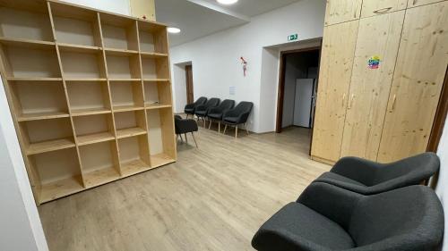 a waiting room with chairs and shelves in a building at Turistická chata Libínské Sedlo in Prachatice