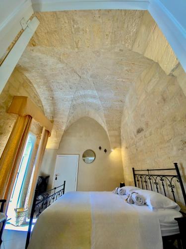Ένα ή περισσότερα κρεβάτια σε δωμάτιο στο Palazzo Storico Riccardi Rollo