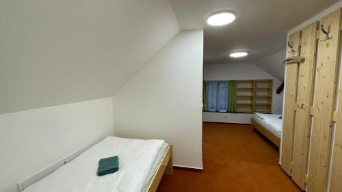 a small room with a bed and a window at Turistická chata Libínské Sedlo in Prachatice