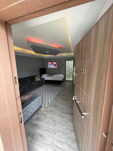 a living room with a couch and a tv in a room at adora apart in Uzungol