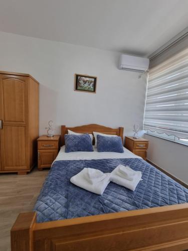 a bedroom with a bed with two towels on it at City Square Apartments in Plav