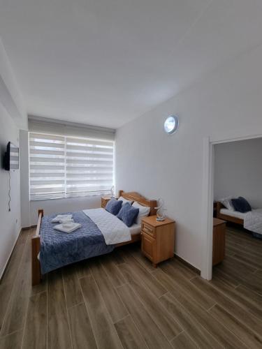 a bedroom with a bed with a blue comforter at City Square Apartments in Plav