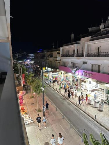 a group of people walking on a street at night at The Heidi's Central House in Kos Town