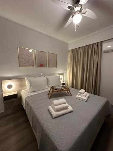 a bedroom with a bed with two towels on it at The Heidi's Central House in Kos Town