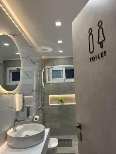 a bathroom with a toilet and a sink at The Heidi's Central House in Kos Town