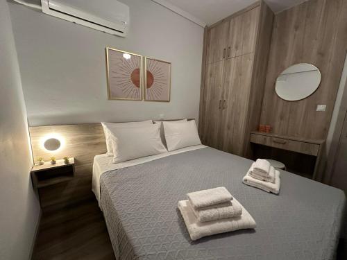 a bedroom with a bed with two towels on it at The Heidi's Central House in Kos Town