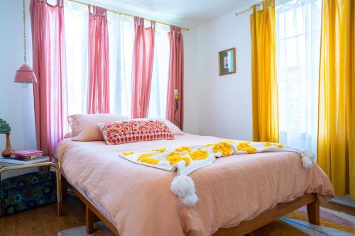 a bedroom with a bed with flowers on it at Stylish, Artsy Bungalow Central Eastside in Austin