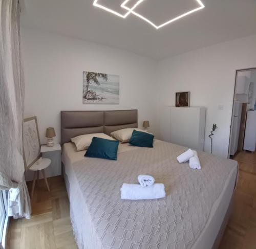a bedroom with a large bed with towels on it at Apartment Milan in Boreti