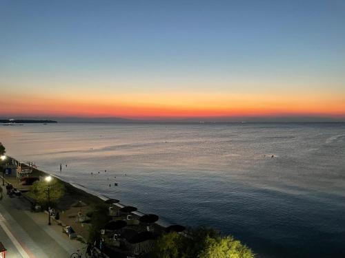 a view of a beach at sunset with people in the water at Siel Residences in Perea
