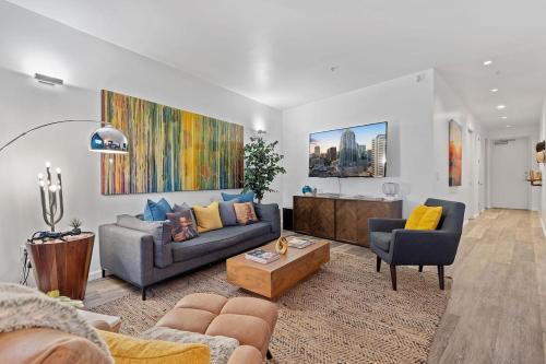 a living room with a couch and a table at 2BR Designer Condo on Trendy East 11th St, Downtown Austin in Austin