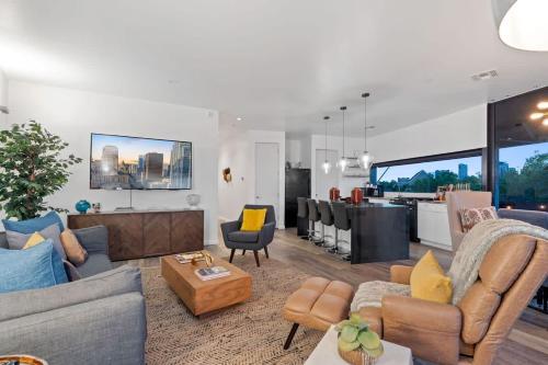 a living room with couches and a dining room at 2BR Designer Condo on Trendy East 11th St, Downtown Austin in Austin