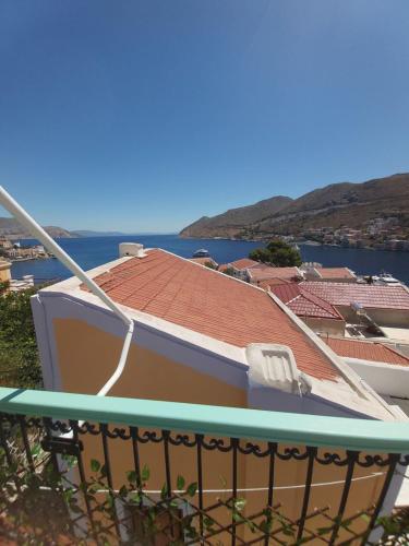 a boat sitting on top of a balcony at 89 Steps Symi in Symi