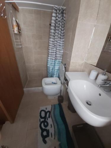 a bathroom with a toilet and a sink at 89 Steps Symi in Symi