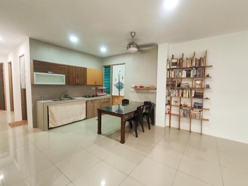 a kitchen and dining room with a table and chairs at Homelite Resort in Miri