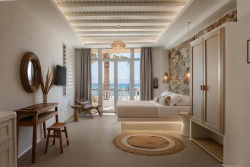a hotel room with a bed and a desk and a bedroom at Casa di Grazia in Naxos Chora