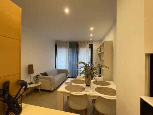 a living room with a table and a couch at Taima Flats 1 in Alicante