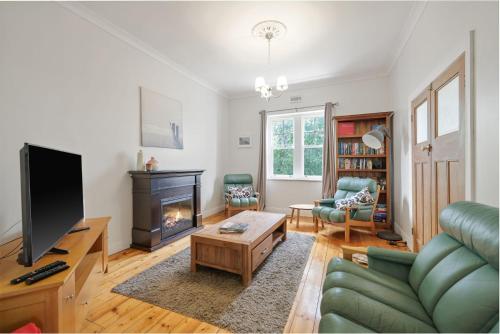 a living room with a couch and a fireplace at Cape Hays in Cape Woolamai