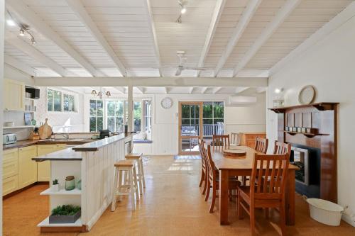 a kitchen and dining room with a table and chairs at Cape Hays in Cape Woolamai