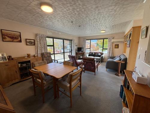a living room with a table and chairs at Home Away From Home in Cromwell