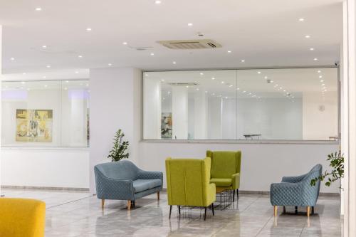 a waiting room with chairs and a mirror at Papantonia Hotel in Protaras