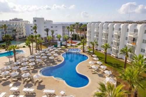 an aerial view of a resort with a swimming pool and chairs at Papantonia Hotel in Protaras