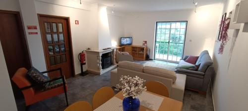 a living room with a couch and a table at Cantinho da Saudade in Góis