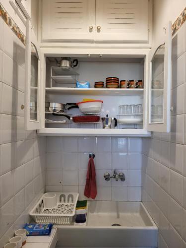 a kitchen with white cabinets and a sink at Appartement front de mer Tanger in Tangier
