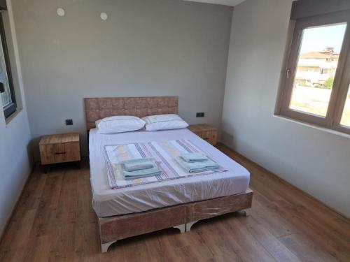 a bedroom with a bed in a room with a window at Villa Miray in Belek