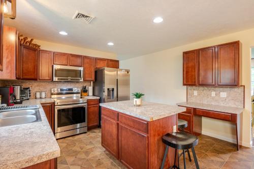 a kitchen with wooden cabinets and stainless steel appliances at Huge villa in the hearth of Poconos near all. in Long Pond