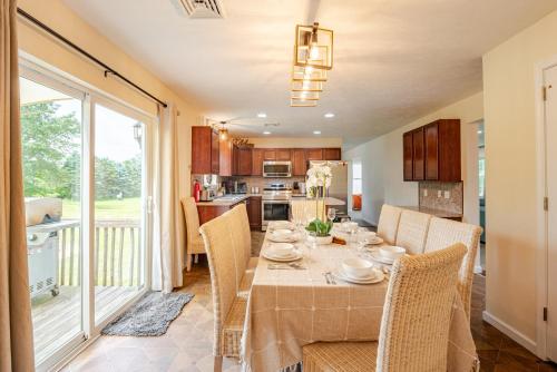 a kitchen and dining room with a table and chairs at Huge villa in the hearth of Poconos near all. in Long Pond
