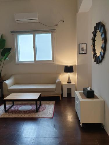 a living room with a couch and a window at Gout Stay in Daegu