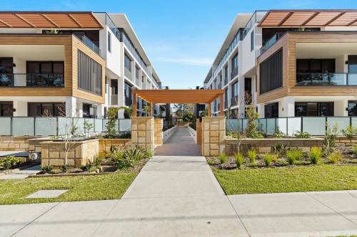 an external view of an apartment building with an orange canopy at Allura Escapes by Experience Jervis Bay in Huskisson