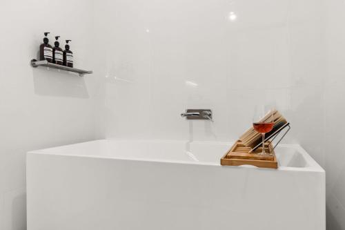 a white sink with bottles on top of it at Allura Escapes by Experience Jervis Bay in Huskisson