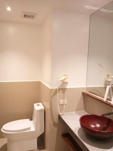 a bathroom with a toilet and a sink at The Paragon Boracay Suites in Boracay