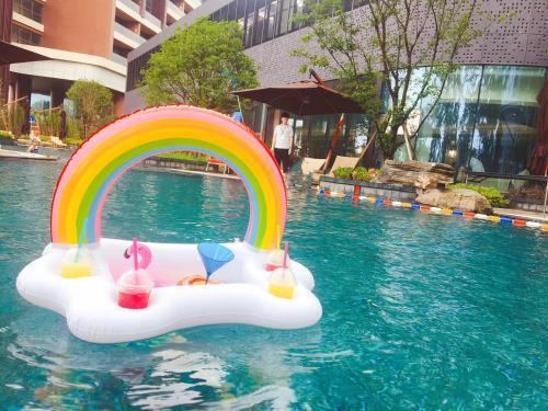 a pool float with a rainbow in the water at Suzhou Marriott Hotel Taihu Lake in Suzhou