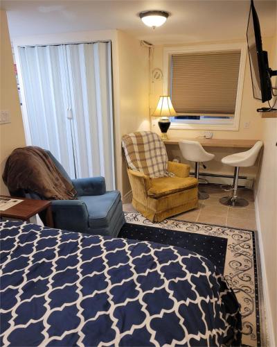 a bedroom with a bed and a living room at Noble Waterfront Suites in Brockville