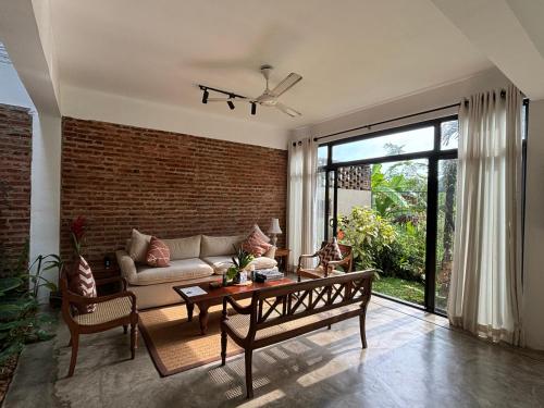 a living room with a couch and a table at Rai Villa Colombo in Colombo