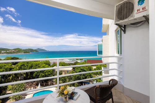 a balcony with a view of the ocean at Sanya Sun Seaview Apartment in Sanya