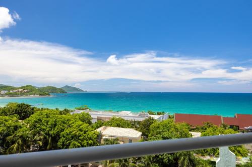 a view of the ocean from a balcony at Sanya Sun Seaview Apartment in Sanya