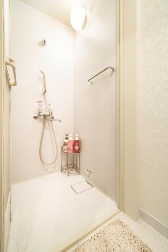 a shower stall in a white bathroom with a shower at 84-2, Shiomi 102, Entire room for rent, 潮見B102 in Tokyo